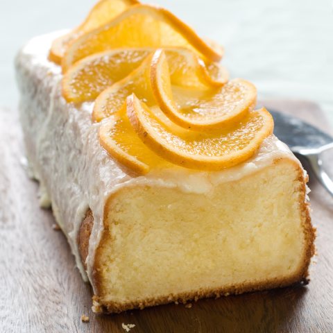 Orange jam cake with icing and orange slices