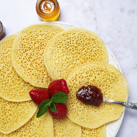 Thousand-hole baghrir pancakes served with strawberries and jam